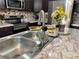 Modern kitchen sink with a gold and black faucet at 6828 Delta Dr, Riverdale, GA 30274