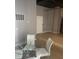 Bright dining area with glass table and four white chairs at 20 Marietta Nw St # 13F, Atlanta, GA 30303