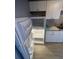 White kitchen with refrigerator and granite countertops at 20 Marietta Nw St # 13F, Atlanta, GA 30303