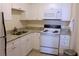 White kitchen cabinets, granite countertops, and appliances at 20 Marietta Nw St # 13F, Atlanta, GA 30303