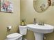 Clean and updated bathroom with pedestal sink and toilet at 5511 E Stoneway Ct, Villa Rica, GA 30180