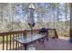 Spacious deck with glass-top table, umbrella, and grill at 5511 E Stoneway Ct, Villa Rica, GA 30180