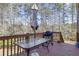 Deck with glass-top table, umbrella, and grill at 5511 E Stoneway Ct, Villa Rica, GA 30180