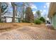A brick patio creates a space for outdoor seating with an old growth tree canopy at 282 Evelyn Nw St, Marietta, GA 30064