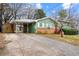 Charming home featuring a covered carport, red front door, and brick accents at 282 Evelyn Nw St, Marietta, GA 30064