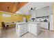 Charming kitchen featuring a center island, white cabinets, and an adjacent dining area with bright yellow walls at 282 Evelyn Nw St, Marietta, GA 30064