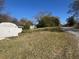 Exterior shot of lush backyard and outbuilding offering ample storage space and serene privacy at 5121 Newark Ave, Clarkdale, GA 30111