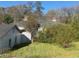 View of backyard featuring a classic home and beautiful trees in a serene, residential setting at 5121 Newark Ave, Clarkdale, GA 30111