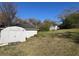 Backyard view featuring outbuilding offering ample storage on a lush lot, blending function and charm at 5121 Newark Ave, Clarkdale, GA 30111