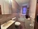 Bathroom with pink tiles, a toilet, a tub, and a sink with a mirror at 5121 Newark Ave, Clarkdale, GA 30111