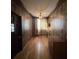 Bedroom featuring hardwood floors, wood paneling, a ceiling fan, and natural light at 5121 Newark Ave, Clarkdale, GA 30111