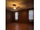 This bedroom offers hardwood floors, wood paneling, a ceiling fan, and natural light at 5121 Newark Ave, Clarkdale, GA 30111