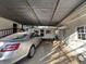 View of carport with car and adjacent storage building at 5121 Newark Ave, Clarkdale, GA 30111