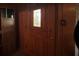 Entryway with a wooden front door with glass inserts and a built-in storage unit at 5121 Newark Ave, Clarkdale, GA 30111