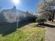 Quaint house with a lush green lawn, mature trees, and inviting walkway, promising a serene setting at 5121 Newark Ave, Clarkdale, GA 30111