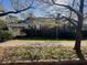Charming bungalow-style home surrounded by mature trees and a green lawn at 5121 Newark Ave, Clarkdale, GA 30111