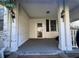 Enclosed front porch with white columns, siding and a covered ceiling at 5121 Newark Ave, Clarkdale, GA 30111