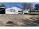 View of detached two-bay garage with extended parking pad on a sunny day at 5121 Newark Ave, Clarkdale, GA 30111