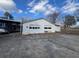 Exterior shot of detached garage with two bays and a large parking pad at 5121 Newark Ave, Clarkdale, GA 30111