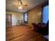 Large living room with gleaming hardwood floors, wood paneled walls, and natural light at 5121 Newark Ave, Clarkdale, GA 30111