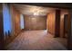 Open living room featuring carpet, wood-paneled walls, and lots of natural light at 5121 Newark Ave, Clarkdale, GA 30111