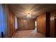 Living room with wood paneled walls, carpet, and lots of natural light at 5121 Newark Ave, Clarkdale, GA 30111