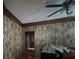 Living room featuring wood-look walls and a ceiling fan, providing a rustic and comfortable atmosphere at 5121 Newark Ave, Clarkdale, GA 30111