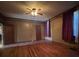 Spacious living room featuring hardwood floors, a ceiling fan, and ample natural light at 5121 Newark Ave, Clarkdale, GA 30111