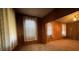 Cozy living room with wood paneled walls, carpet, and lots of natural light at 5121 Newark Ave, Clarkdale, GA 30111