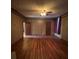 Spacious living room featuring hardwood floors, a ceiling fan, and ample natural light at 5121 Newark Ave, Clarkdale, GA 30111
