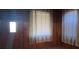 Living room featuring wood paneled walls, carpet, and lots of natural light at 5121 Newark Ave, Clarkdale, GA 30111