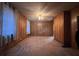 Cozy living room with wooden paneling, a ceiling fan, and bright windows for natural light at 5121 Newark Ave, Clarkdale, GA 30111