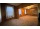Inviting living room with wood-paneled walls, soft carpet, and bright windows with patterned curtains at 5121 Newark Ave, Clarkdale, GA 30111