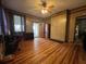 Living room featuring hardwood floors, wood paneling, and a ceiling fan at 5121 Newark Ave, Clarkdale, GA 30111