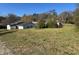 View of front yard with sunny sky and the home in the background at 5121 Newark Ave, Clarkdale, GA 30111