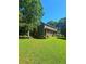 Spacious backyard with lush green lawn and mature trees at 4449 Inns Brook Dr, Snellville, GA 30039