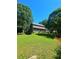 Expansive backyard featuring a large lawn, mature trees and garden at 4449 Inns Brook Dr, Snellville, GA 30039