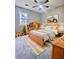 Bright bedroom featuring a wood bed, ceiling fan and charming decor at 4449 Inns Brook Dr, Snellville, GA 30039