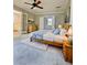 Comfortable bedroom featuring a wood bed, ceiling fan and adjoining bathroom at 4449 Inns Brook Dr, Snellville, GA 30039