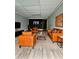 Modern living room featuring hardwood floors, brick accent wall, and brown leather furniture set at 4449 Inns Brook Dr, Snellville, GA 30039