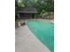 Backyard pool with an adjacent pool house in a serene outdoor setting at 4449 Inns Brook Dr, Snellville, GA 30039