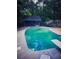 A diving board stands ready next to the freeform backyard pool and pool house at 4449 Inns Brook Dr, Snellville, GA 30039
