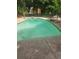 Backyard pool being cleaned, set in a private yard with lush trees around the fence at 4449 Inns Brook Dr, Snellville, GA 30039