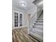 Bright foyer staircase featuring white trim, hardwood floors, and carpeted steps to the second floor at 4449 Inns Brook Dr, Snellville, GA 30039