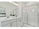 Modern bathroom featuring double vanity, white cabinets, and a frameless glass shower enclosure at 1084 Battery Park Rd, Decatur, GA 30033
