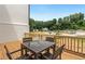 Deck with table and chairs, offering a relaxing outdoor space and wooded views at 1084 Battery Park Rd, Decatur, GA 30033