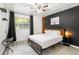 Main bedroom with a queen-size bed and dark accent wall at 1225 Church St # O, Decatur, GA 30030