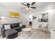 Comfortable living room boasts a gray sofa, modern decor, and an open view into the dining area at 1225 Church St # O, Decatur, GA 30030