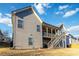 Gray house exterior with deck, stairs, and landscaping at 1317 Elmswood Glen Way, Lawrenceville, GA 30045