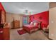 Bedroom with queen bed and red accent wall at 4504 Sterling Pointe Nw Dr, Kennesaw, GA 30152